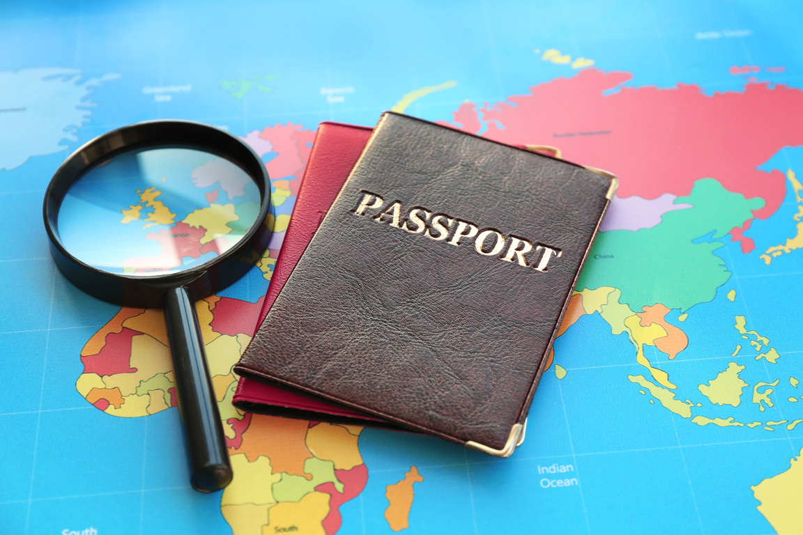 Magnifying Glass and Passports on a World Map