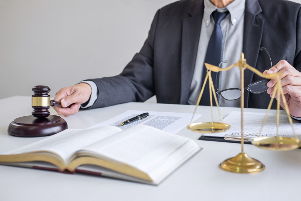 Judge gavel with Justice lawyers, Businessman in suit or lawyer working on a documents in courtroom. Legal law, advice and justice concept